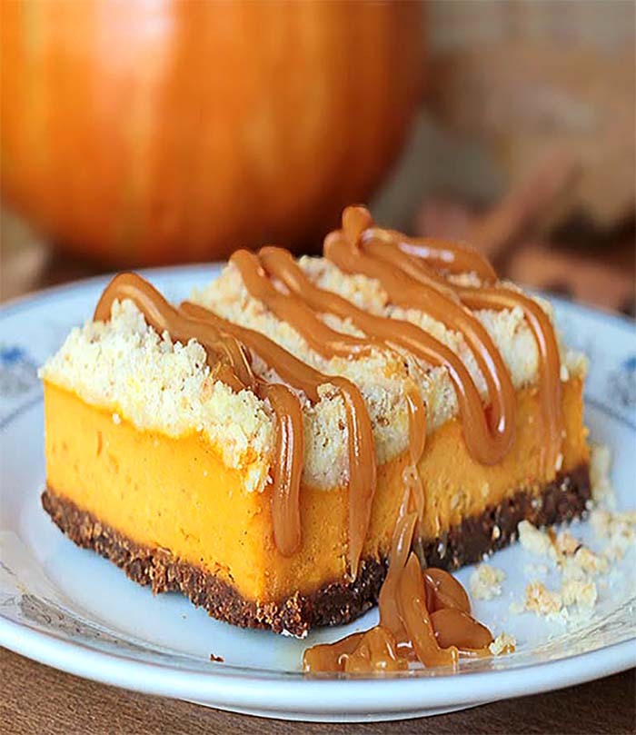 These pumpkin cheesecake bars are the PERFECT fall dessert. From their crunchy ginger cookie crust,  creamy pumpkin cheesecake filling, to the buttery streusel, the textures and flavors are simply divine.