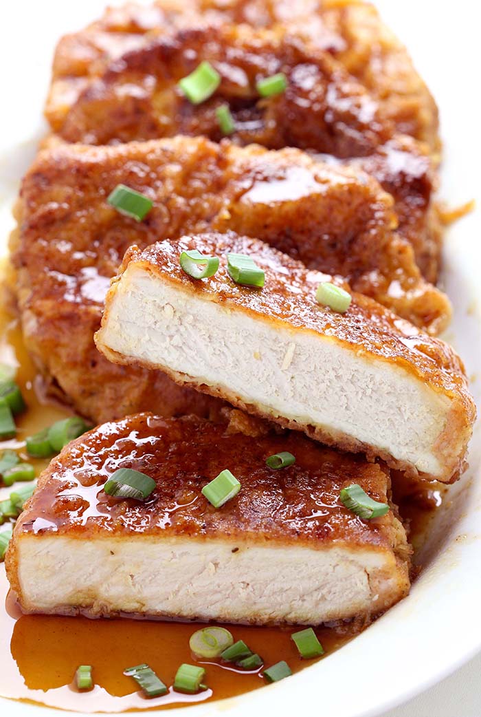 Honey Garlic Pork Chops - Double dipped and deliciously crunchy pork chops, coated in a sticky honey garlic sauce that is out of this world.