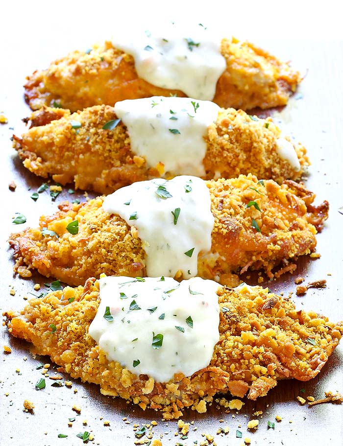 Full of flavor, tender chicken coated in cheddar cheese, ritz cracker crumbs and baked to crispy perfection. Top with a creamy sauce, Crispy Cheddar Chicken is to die for!