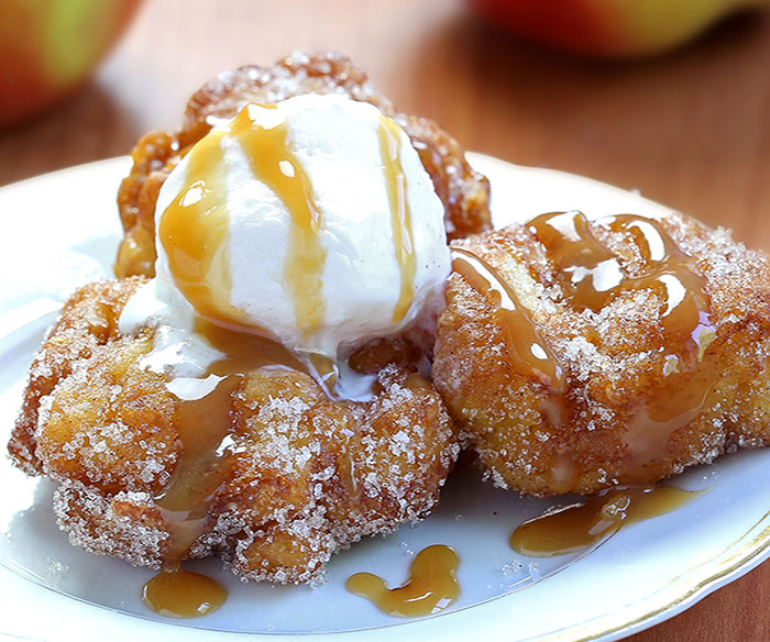 Apple Fritters - deep fried homemade dessert filled with apples, cinnamon and coated in cinnamon sugar or covered with sweet glaze...you just can’t get enough of them!