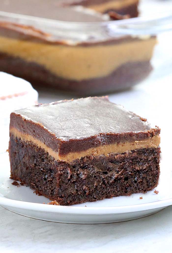 Chocolate Peanut Butter Fudge Cake is the ultimate chocolate peanut butter dessert recipe. A fudgy chocolate cake layer,  creamy peanut butter filling, and silky chocolate frosting on top are such a fantastic combination. It’s rich, creamy, smooth, decadent, and to die for.