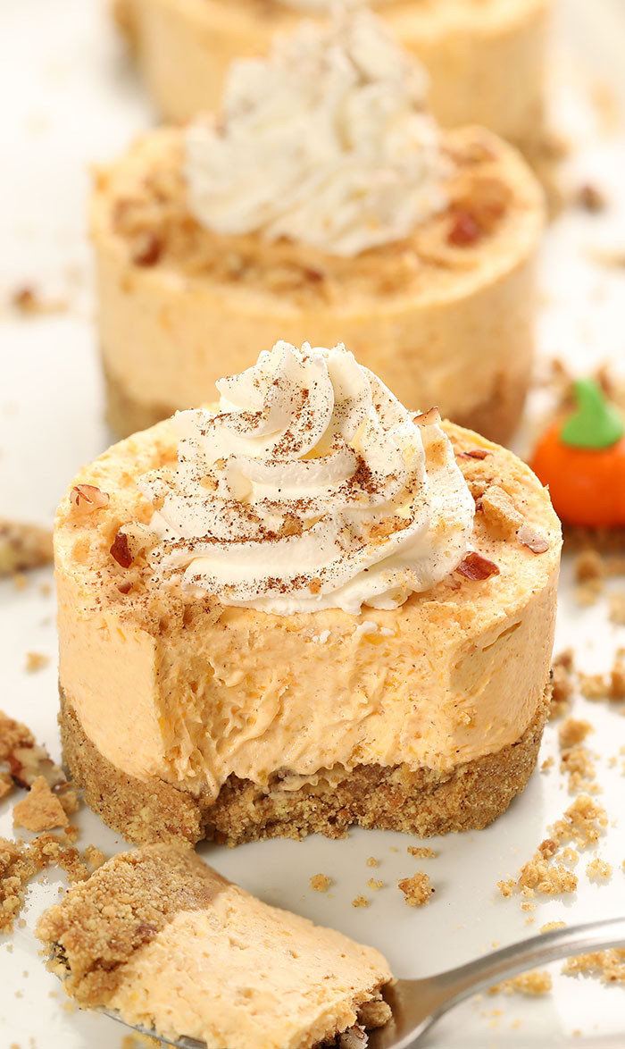 No Bake Mini Pumpkin Cheesecakes are the perfect Thanksgiving or Halloween dessert for a crowd! Creamy homemade pumpkin cheesecake on top of a graham cracker crust, top it with whipped cream or serve a la mode!
