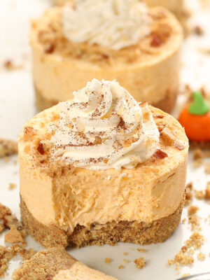 No Bake Mini Pumpkin Cheesecakes are the perfect Thanksgiving or Halloween dessert for a crowd! Creamy homemade pumpkin cheesecake on top of a graham cracker crust, top it with whipped cream or serve a la mode!